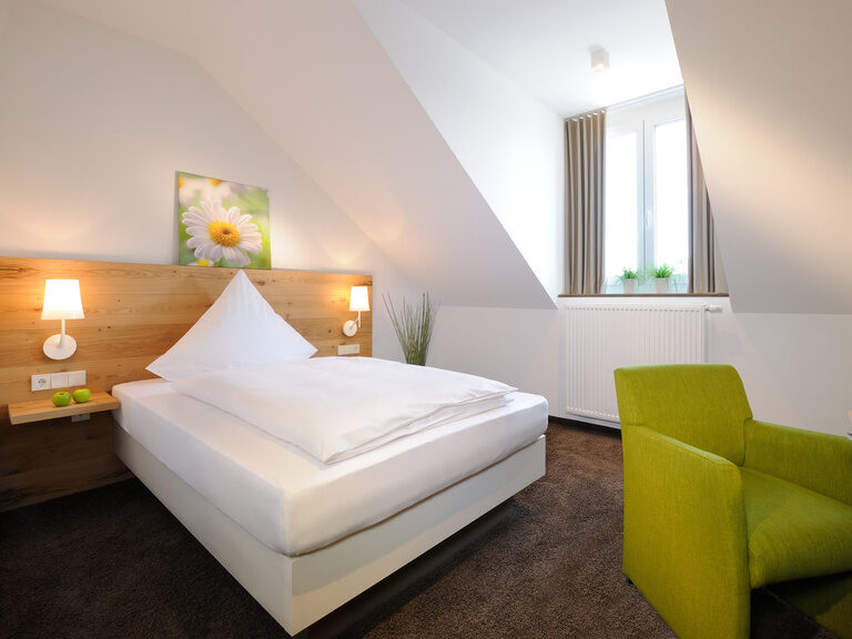 Das Buisness-Zimmer Kingsize bietet ein sehr großes Bett und einen Sessel